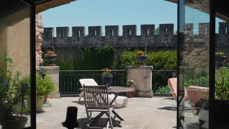 slow orbiting shot of patio furniture sitting in the sun at chateau de pouzilhac