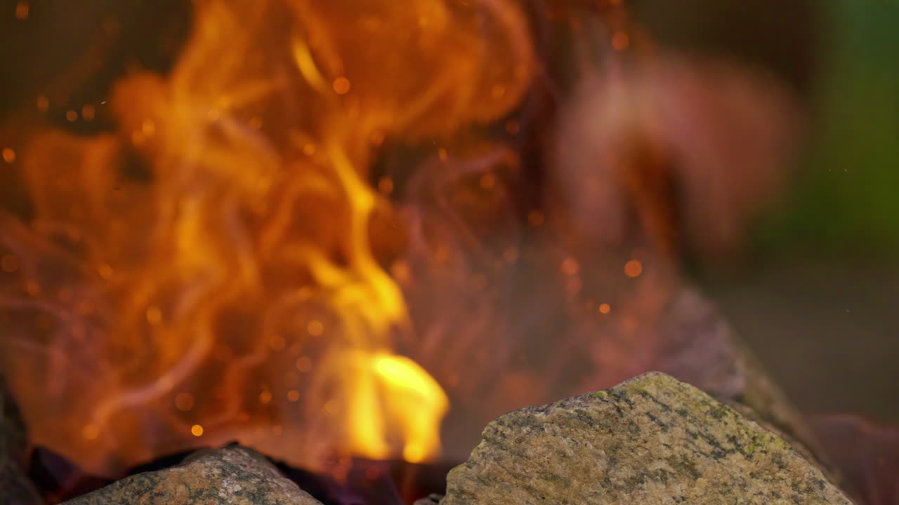 aislado cerca de un fuego ardiendo y chispas y brasas flotando con el humo - detalle cautivador de cámara lenta
