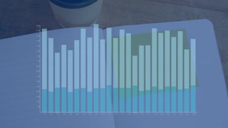 Animation-of-financial-graph-over-notebook-on-desk