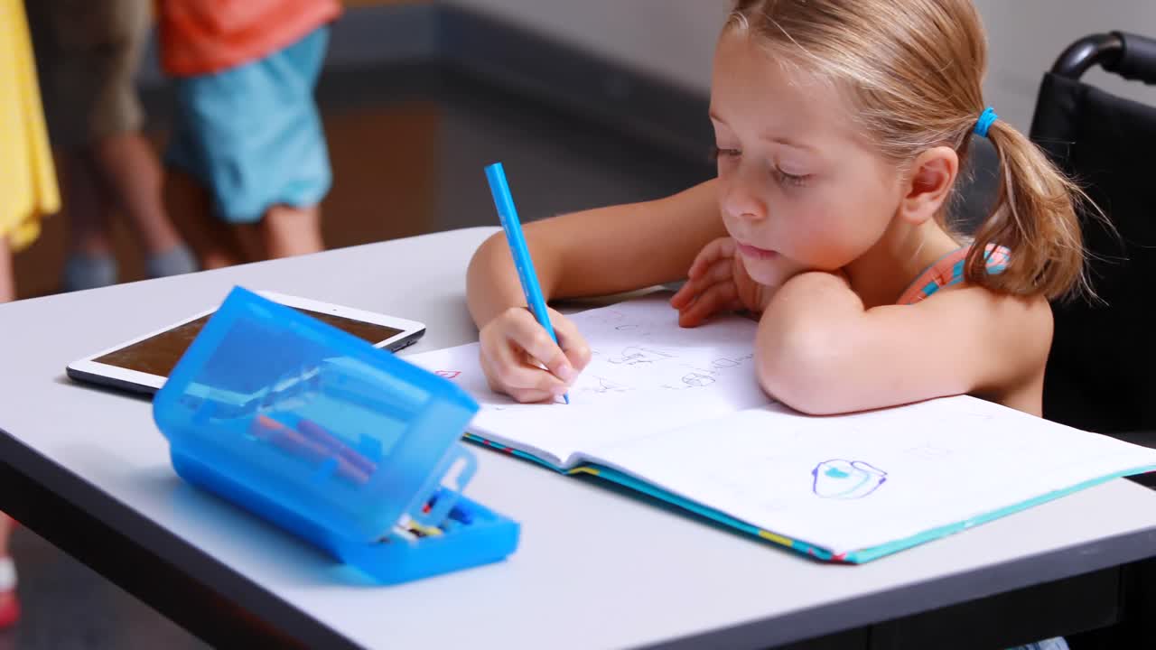 Disabled schoolgirl studying in classroom | Premium Stock Video Footage