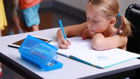 disabled schoolgirl studying in classroom
