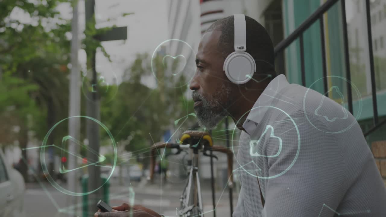 Animation of digital icons over man with headphones and smartphone sitting in city street