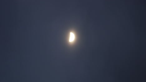 Time-lapse-of-a-half-moon-passing-through-the-cloudy-night-sky,-a-mystery-fairyland-scene