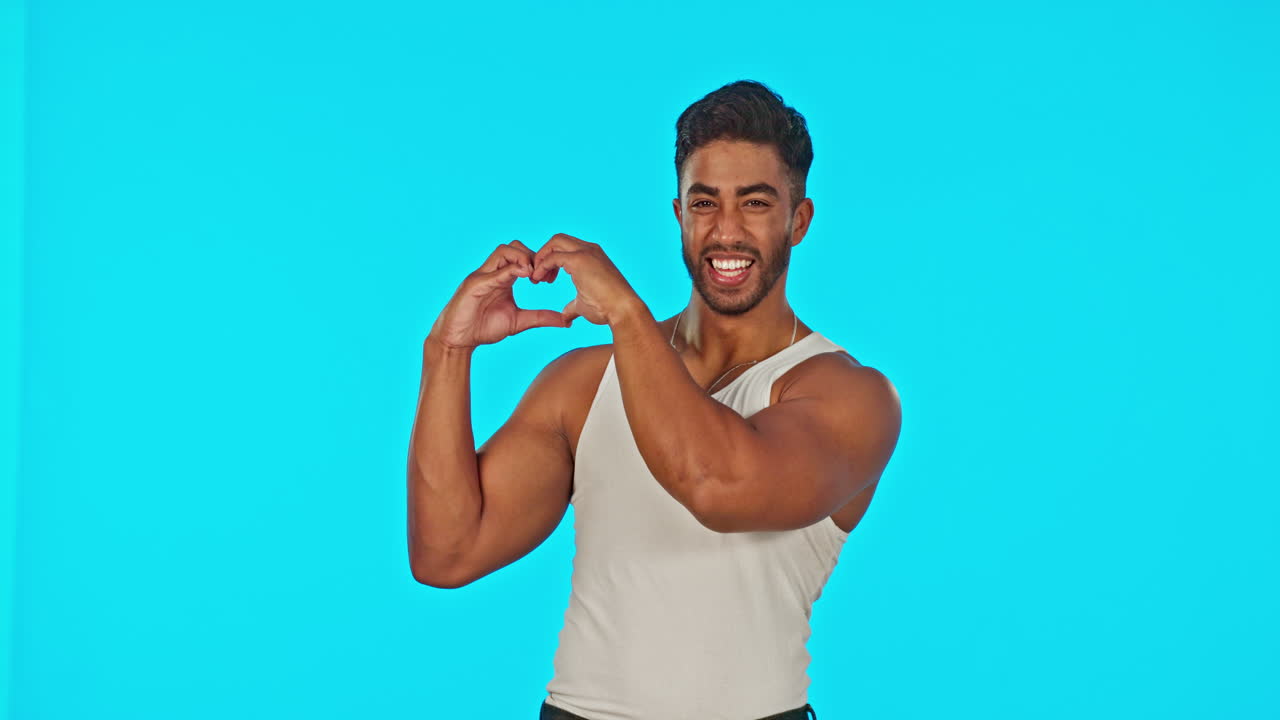 Heart, hand gesture and a laughing man on a blue