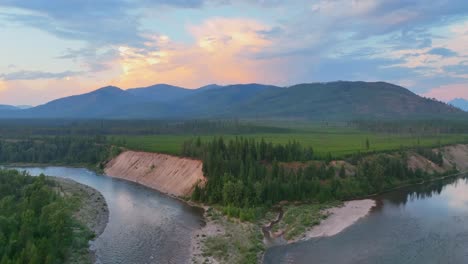 aerial approach towards confluence of middle fork and north fork of flathead river at sunset in montana