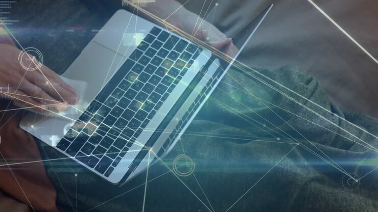 Woman typing on laptop on sofa, displaying tech interface with network diagrams and data charts