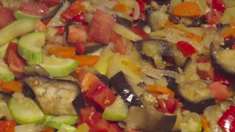 salt sprinkling on steaming traditional spanish pisto dish, closeup