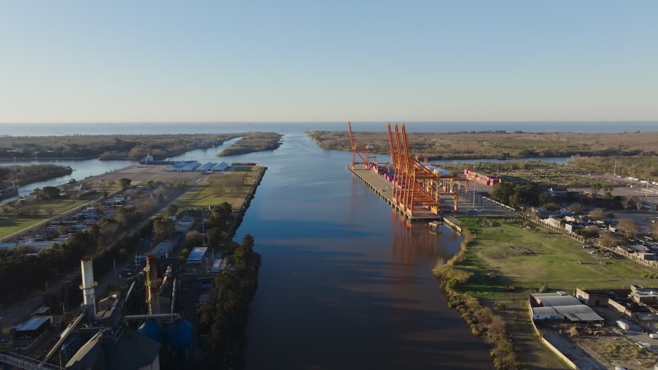 Drone video of shipping vessels and cranes handling cargo on Río de la Plata, Argentina, maritime commerce hub