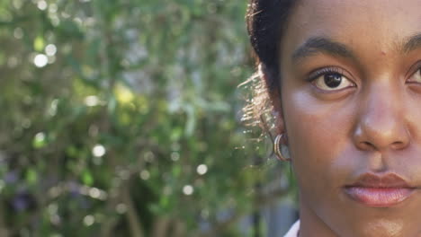 a young african american woman gazes intently at the camera with copy space