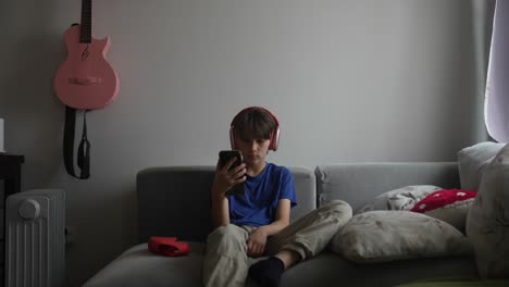 Boy Listening to Music on a Couch