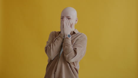 smiling bald woman in brown corduroy shirt