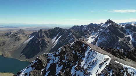 aerial orbits successful climbers on mountain peak in western bolivia