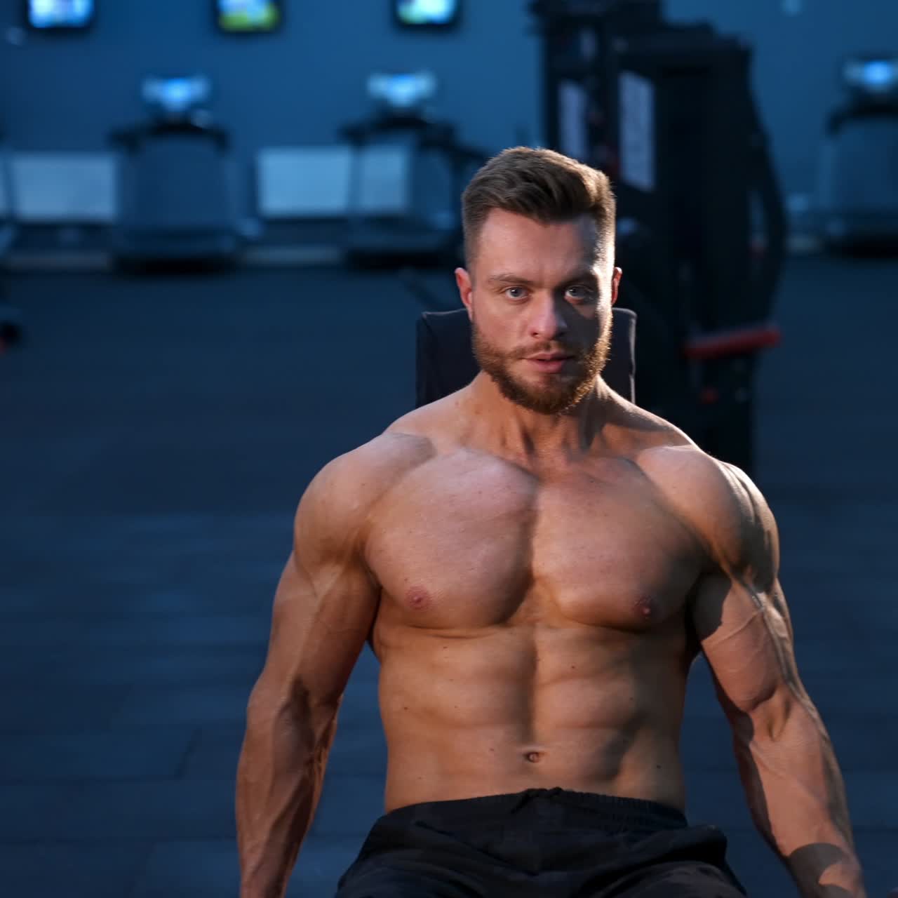 Young bodybuilder holding dumbbell