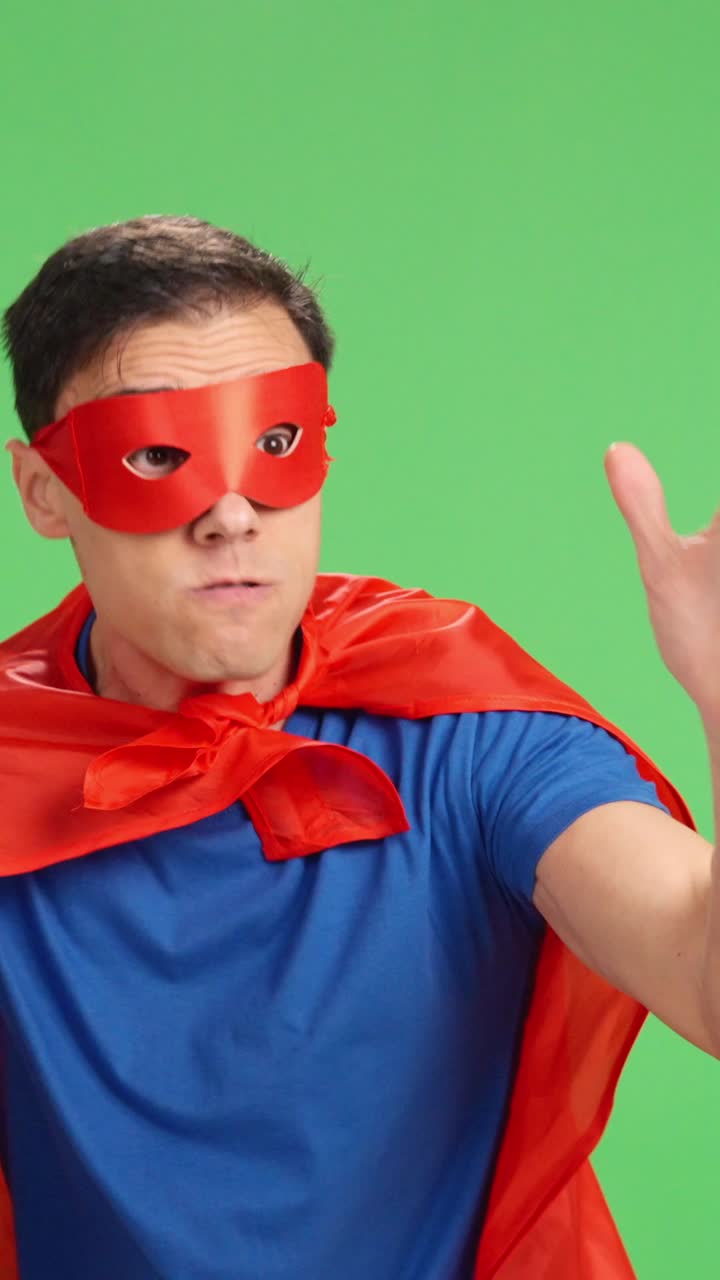 Superhero suffering defeat on green screen