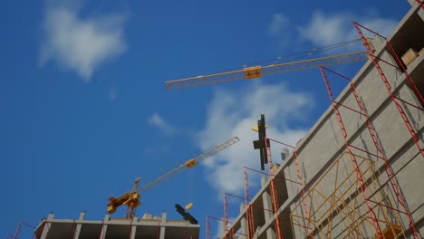 construction site with cranes and scaffolding