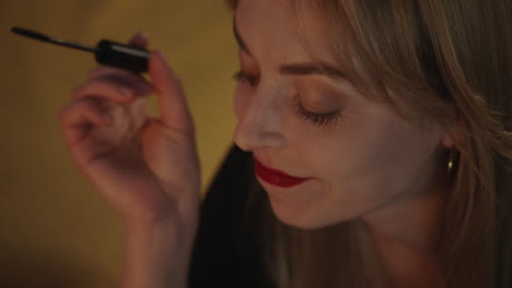 woman applying mascara