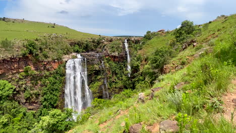 lisbon falls sabie waterfall south africa incredible lush green grass in wind spring summer daytime scenic landscape peaceful view adventure johannesburg gem slow motion pan left