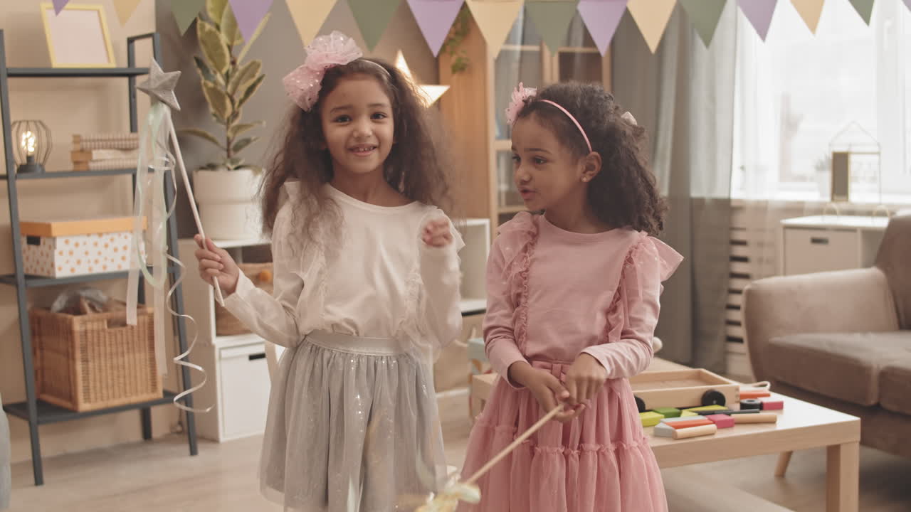 Cute Mixed-Race Sisters with Toy Wands