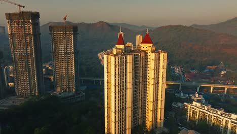 mumbai cityscape with construction and high-rise buildings at sunrise