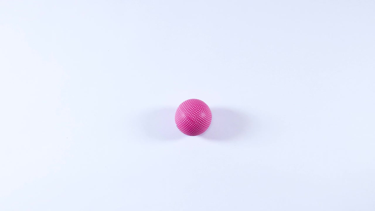 A pink ball rolls smoothly across a surface