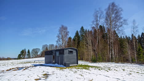 Beautiful-timelapse-shot-throughout-various-seasons-of-a-wooden-cottage-along-rural-countryside