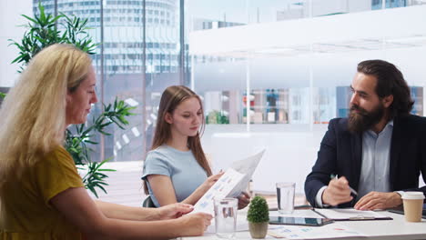 financial adviser providing clients with informative leaflets