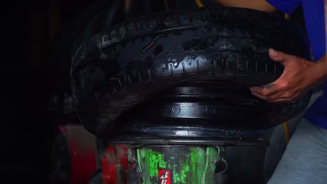 close up shot of the process of removing car tyre from the rim