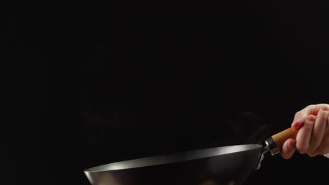 stir-frying colorful peppers in a wok
