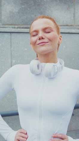 confident and energized: a young woman enjoys a moment of bliss after her workout, radiating positivity with headphones and a focused expression
