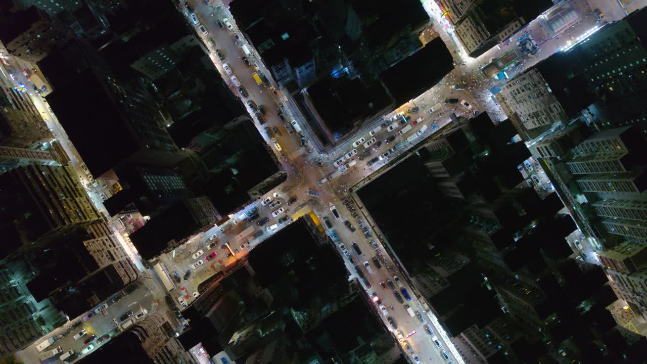 Top down rotating aerial of Hong Kong Kowloon with traffic and glowing street grid pattern