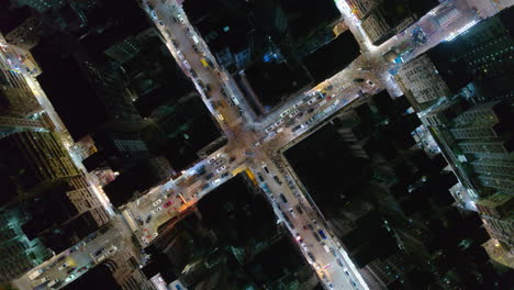 top down rotating aerial of hong kong kowloon with traffic and glowing street grid pattern
