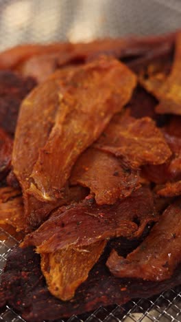 close-up view of various types of dried meat snacks.