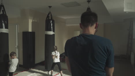 boxer closes face during sparring in gym. sportsman blocks facial punches exercising with partner in fighting club slow motion. combat techniques