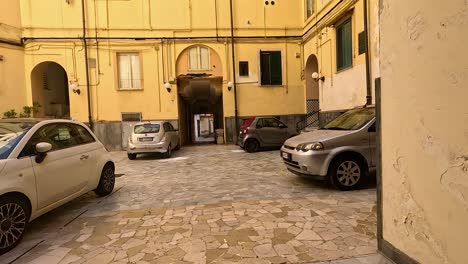 cars parked in a historic courtyard