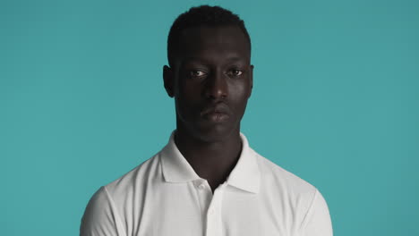 serious african american man on blue background.