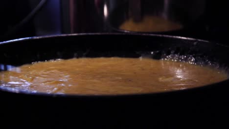scrabbled eggs cooking in a pan late at night