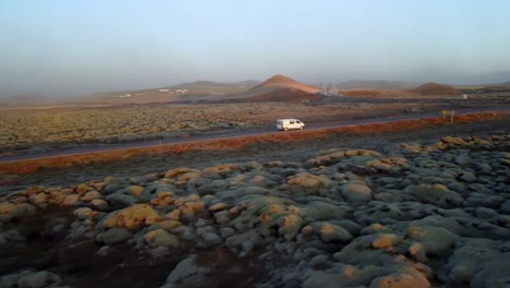 flying over a dirt road at sunset in iceland