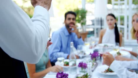 waiter taking an order from customers