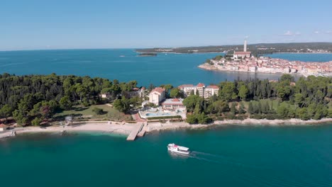 croatia tourism concept - boat approaching beautiful scenic port on adriatic sea coastline