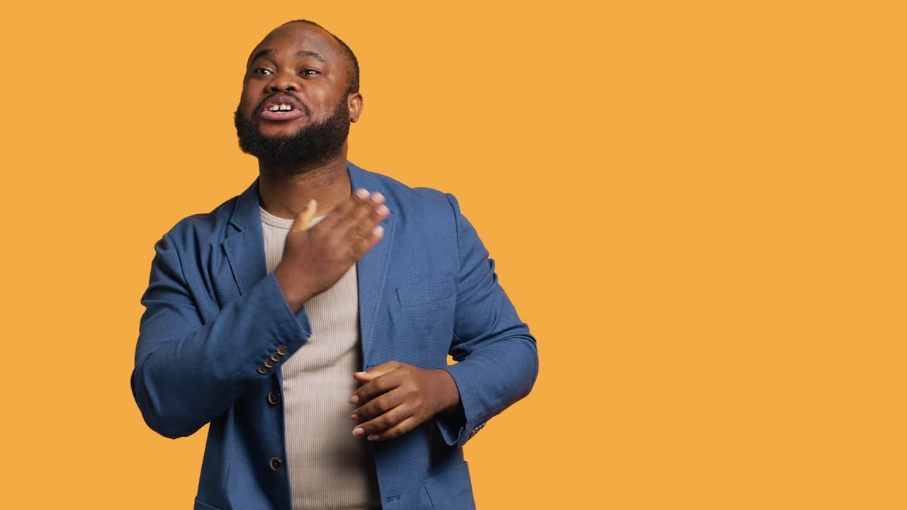 Portrait of joyful man celebrating, studio background