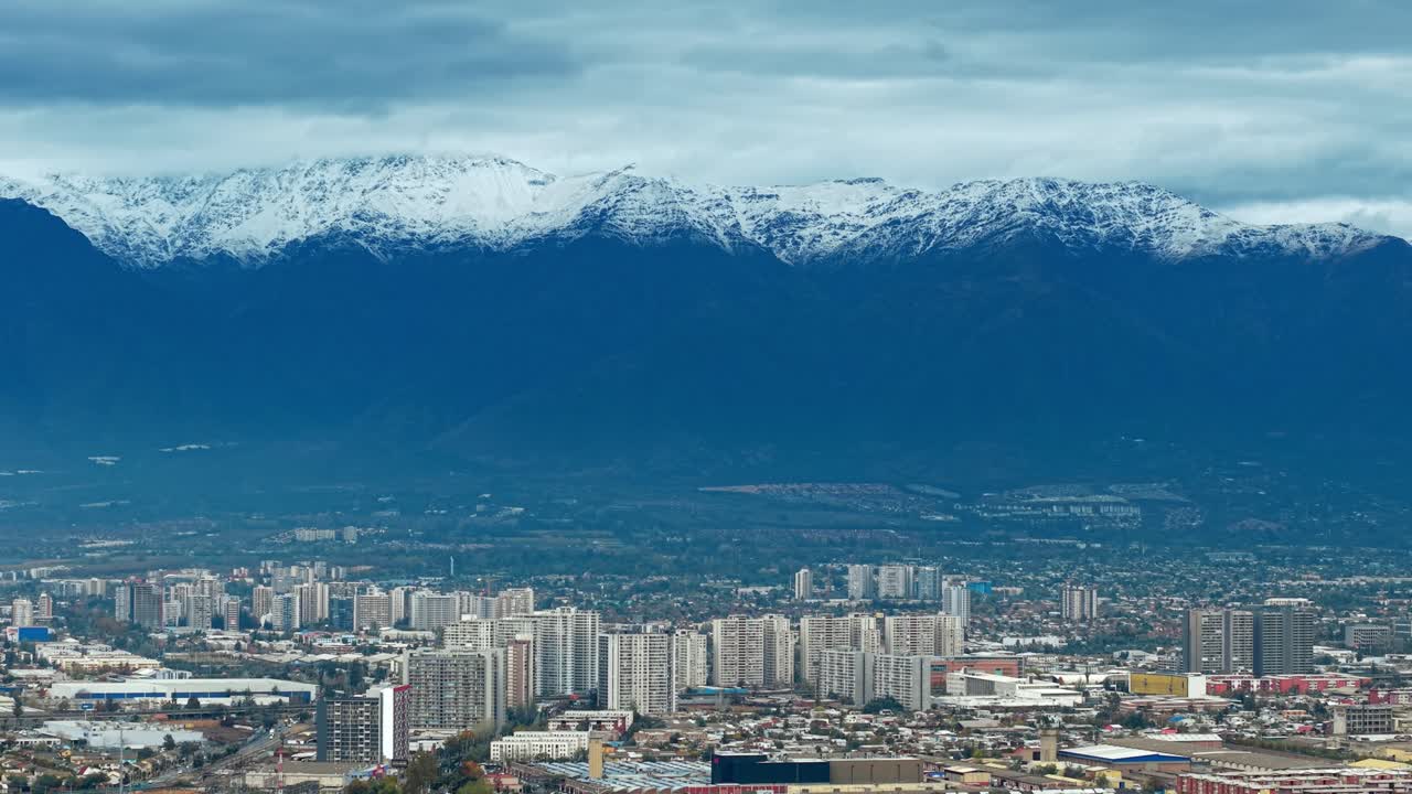 Urban skyline meets the snowy Andes in this breathtaking high-altitude city panorama.