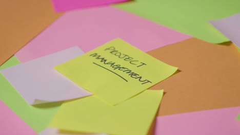 Business-Concept-Of-Revolving-Sticky-Notes-With-Project-Management-Written-On-Top-Note-1