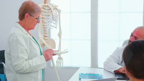 radiologist doctor holding presentation using human skeleton