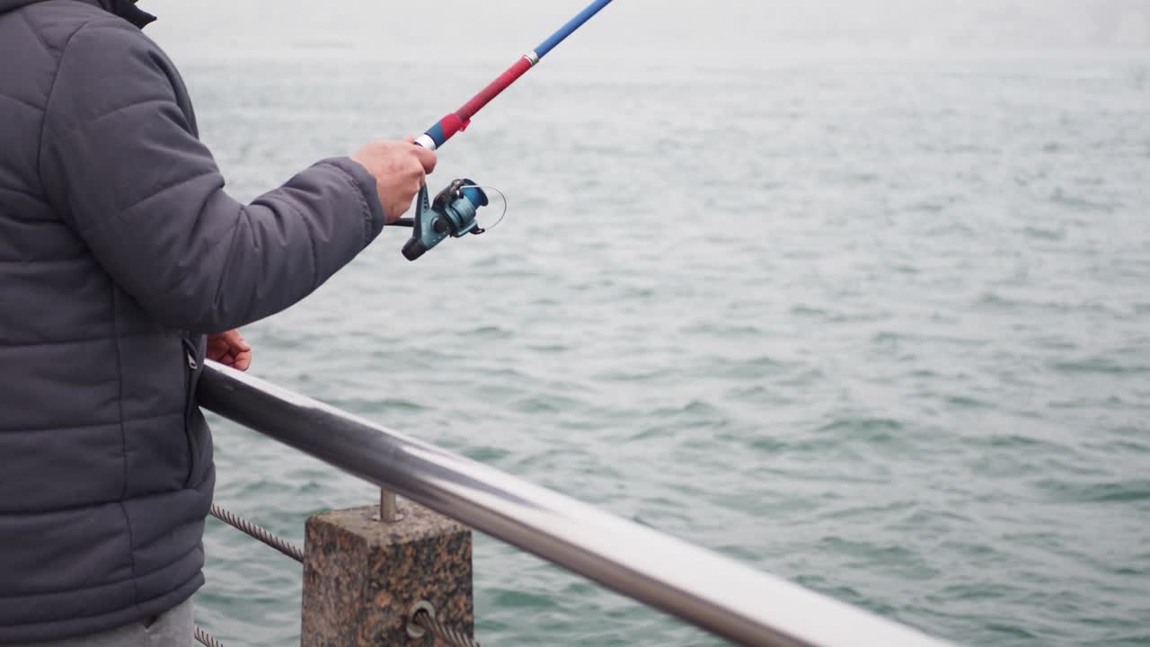 Man Fishing from a Pier