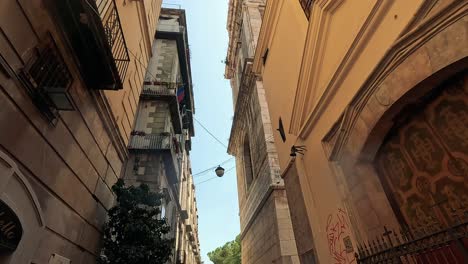 people walking through a narrow, graffiti-covered alley