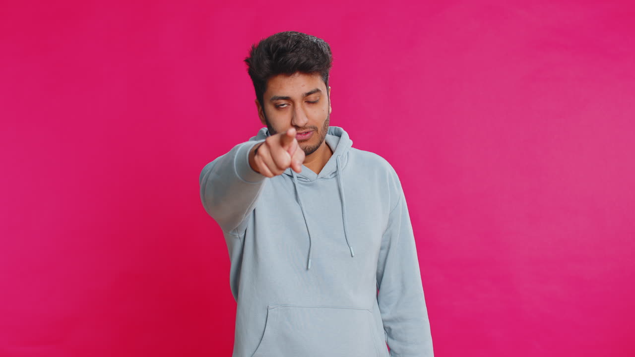 Happy indian smiling man pointing finger to camera making winner choice showing direction select