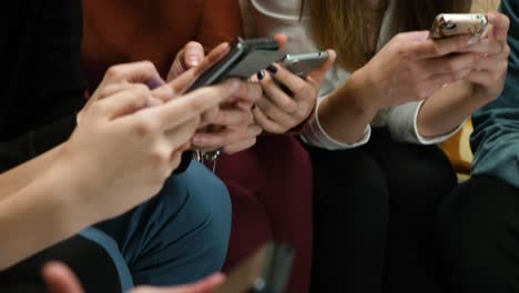 group of friends using smartphones