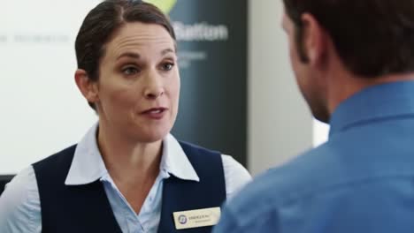 a friendly interaction: customer service professional engaging with client at a business reception, demonstrating effective communication and professionalism