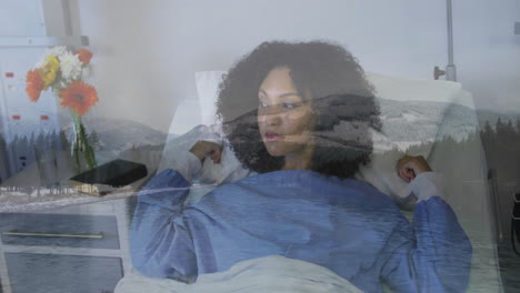 resting in hospital bed, woman with animation of serene lake and mountain