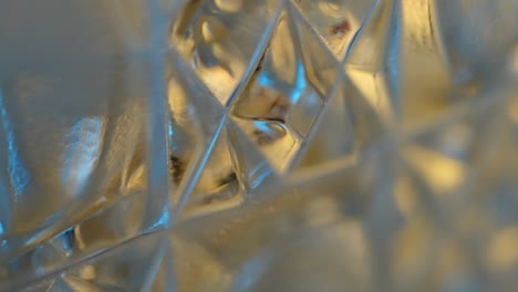 macro view of light refracting through a crystal goblet, carafe, or glass - trippy background